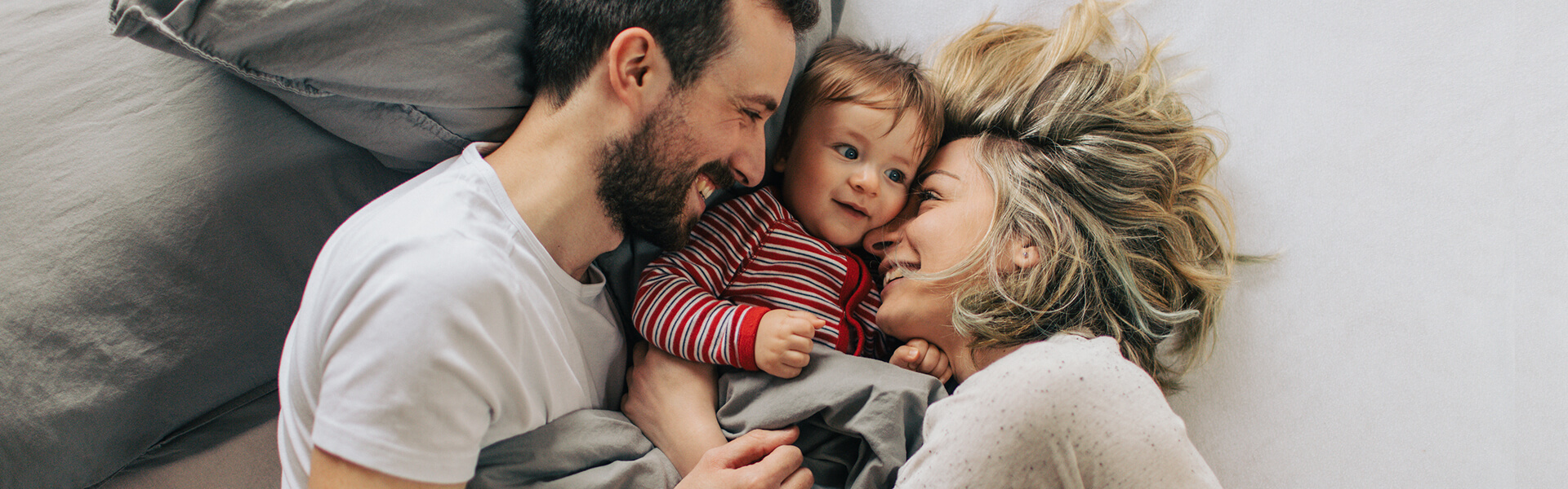 mom, dad and little boy laughing together