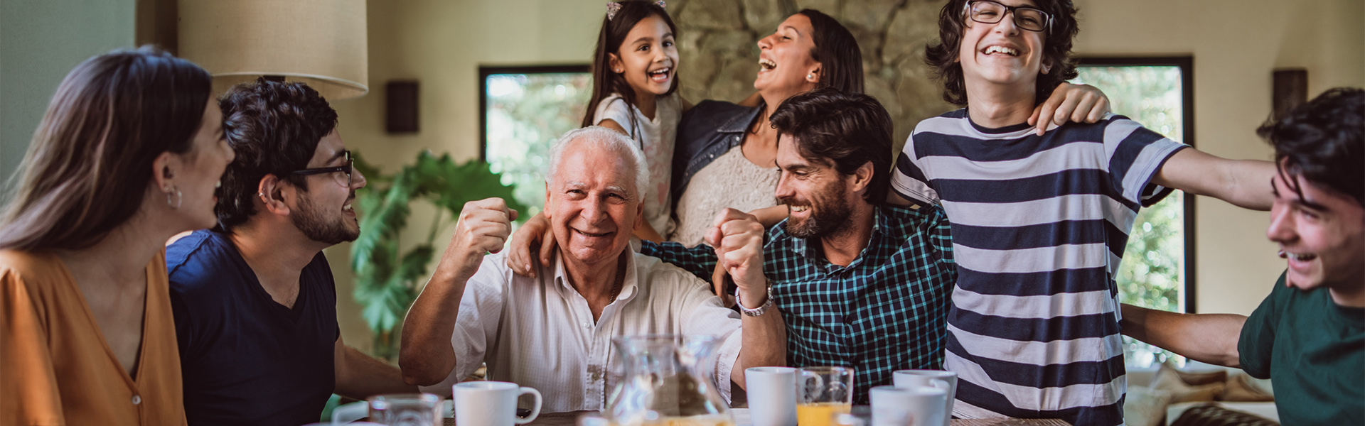 family members of all ages enjoying having breakfast together