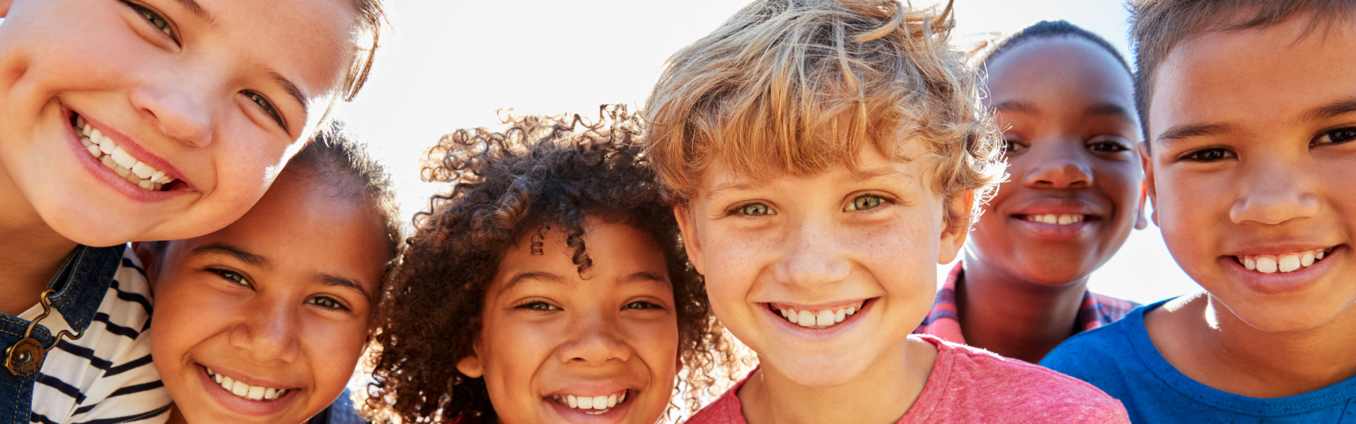 smiling kids looking at a camera